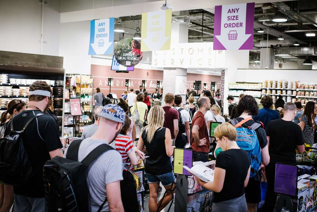 Crowd of people queuing at supermarket